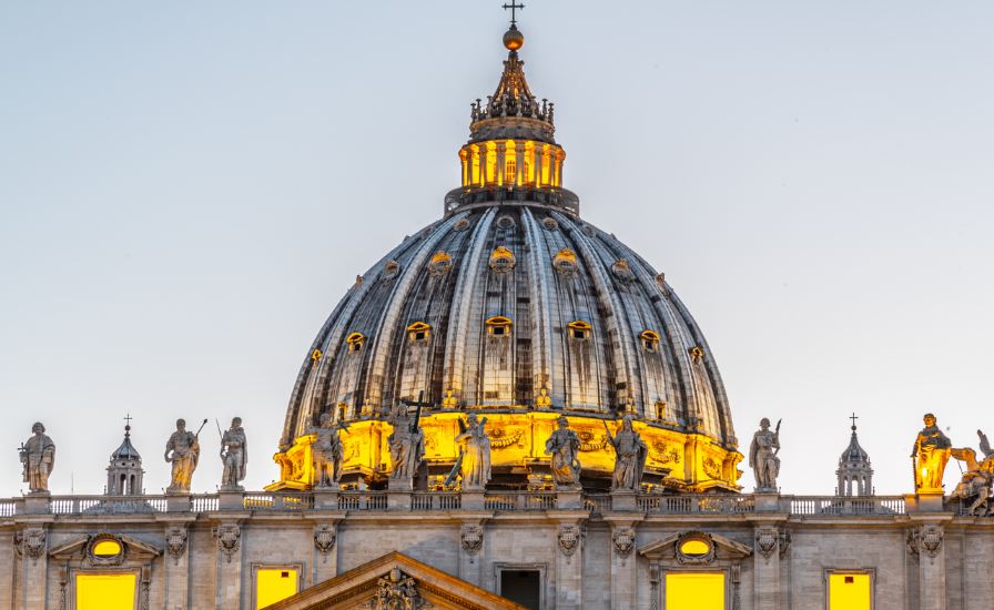 Vatican dome glowing in the evening light, highlighting its grandeur. Construction of the Dome