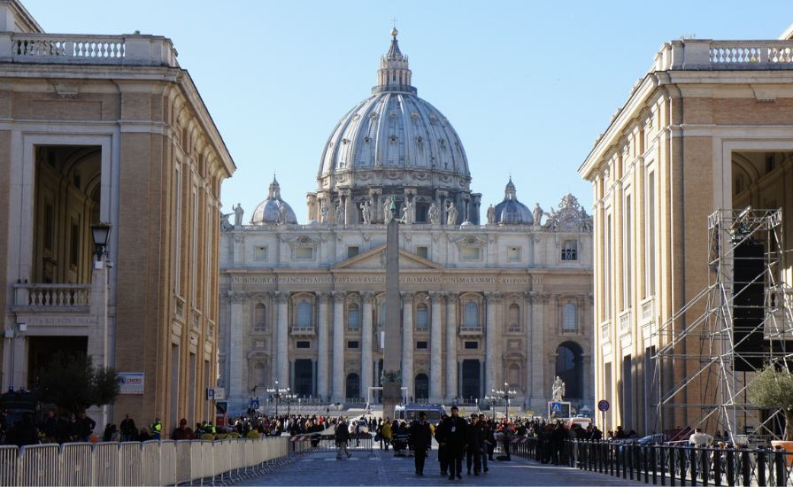 Exterior view of St. Peter's Basilica in Vatican City, showcasing its iconic dome and intricate architecture.
