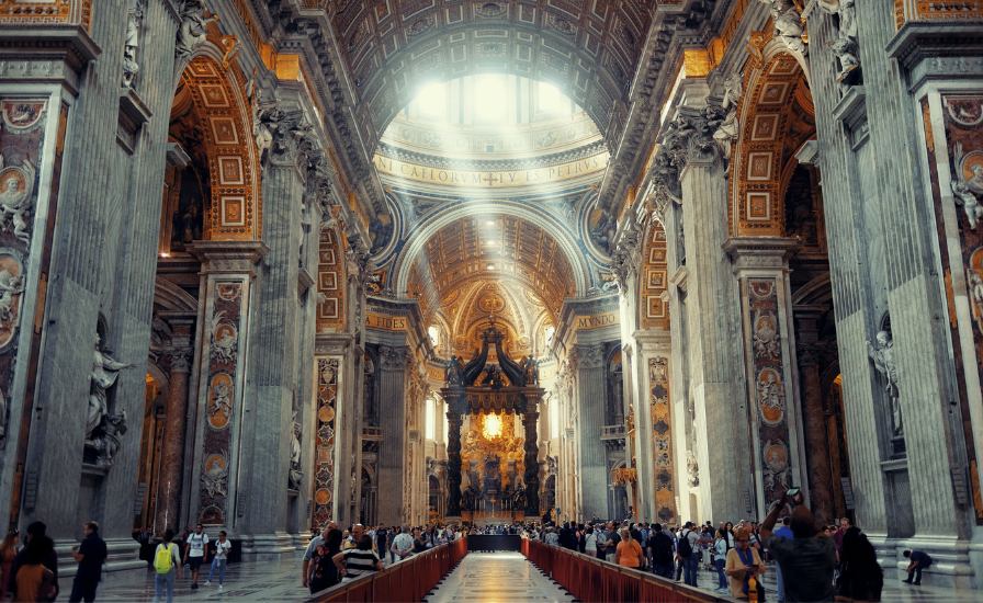 Interior of St. Peter's Basilica with ornate ceiling and dome
