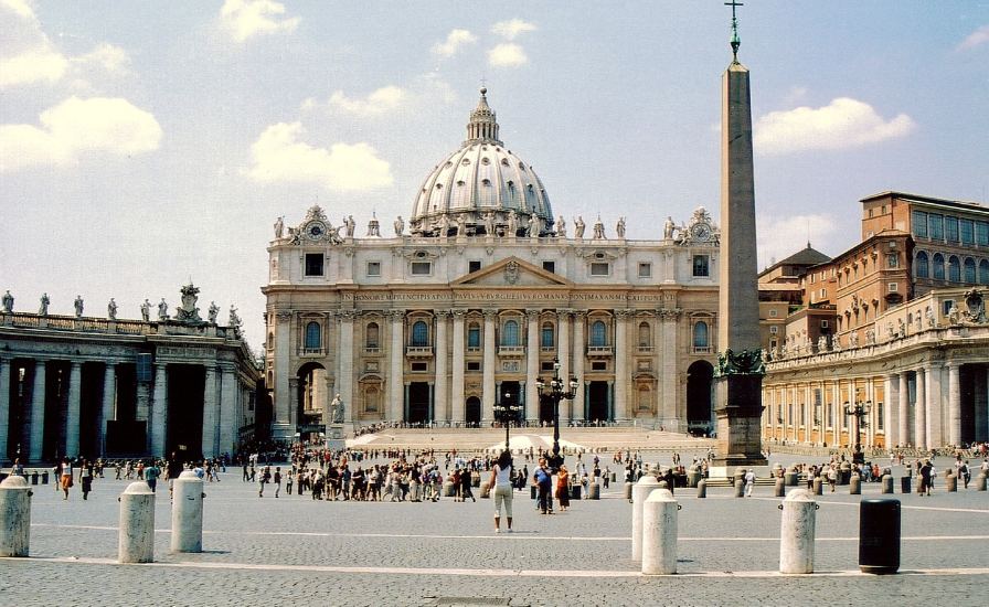 A bustling, grand building filled with numerous individuals. Discover the wonders of St. Peter's Basilica
